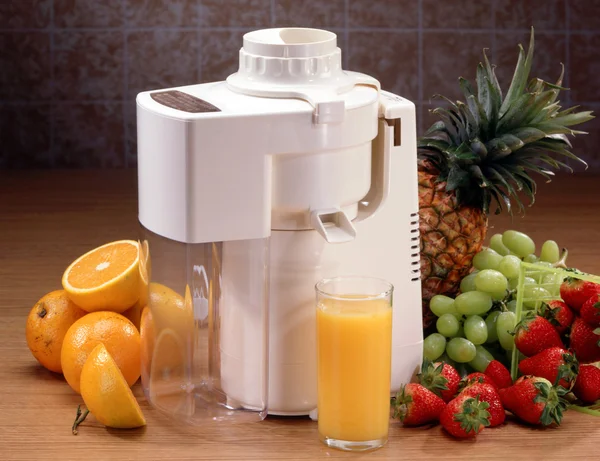 Juicer with glass and fruit — Stock Photo, Image