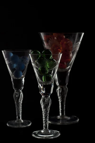 Different glasses full with marbles — Stock Photo, Image