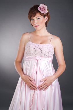 pembe elbiseli bir genç kadın güzel gebelik