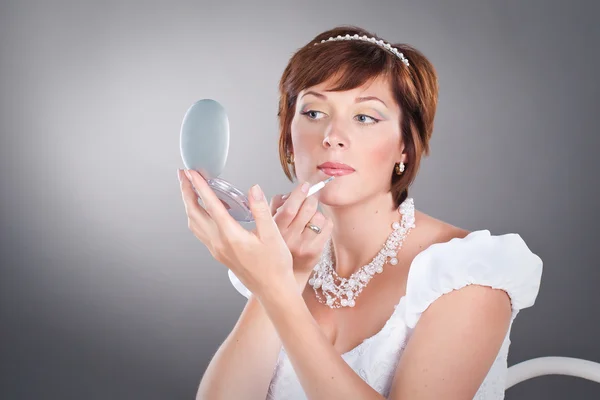 stock image Young bride is doing makeup studio shoot