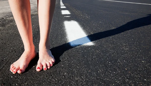 stock image Barefoot girl on the road