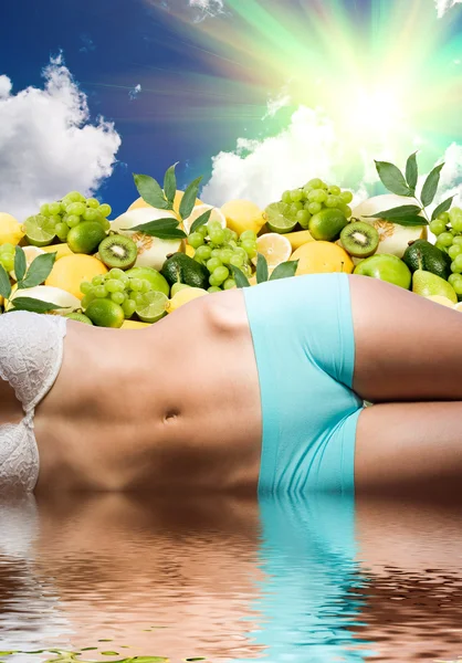 Woman body in water over fresh fruits and sunny sky — Stock Photo, Image
