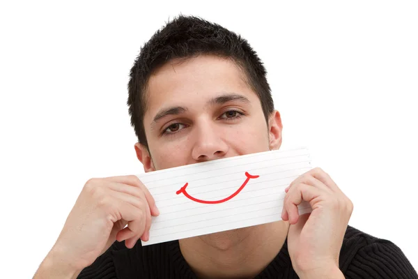 Usmívající se papír v ruce mladého muže — Stock fotografie