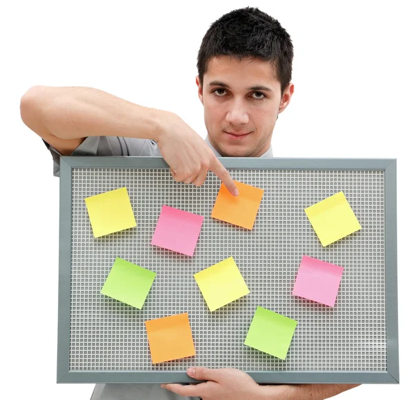 Young man showing onto the reminder board — Stock Photo, Image