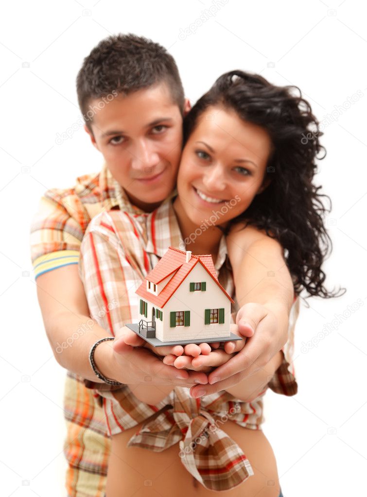 Happy couple with miniature house