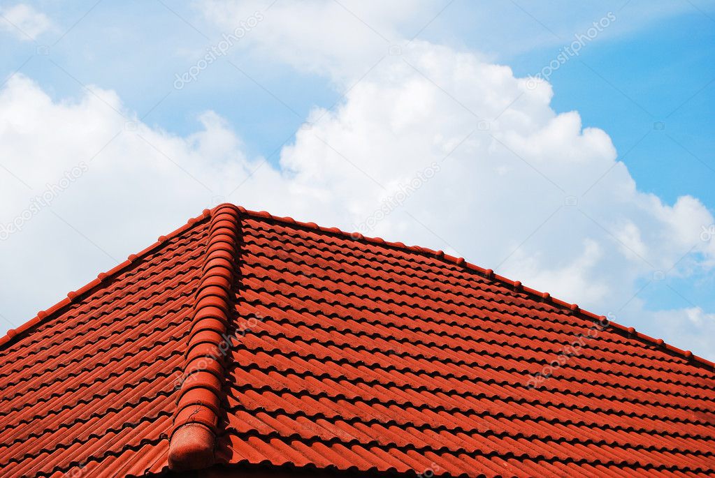 Grunge red roof with cloudy blue sky