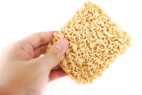 Hand holding a block of Instant noodles isolated on white backgr — Stock Photo, Image