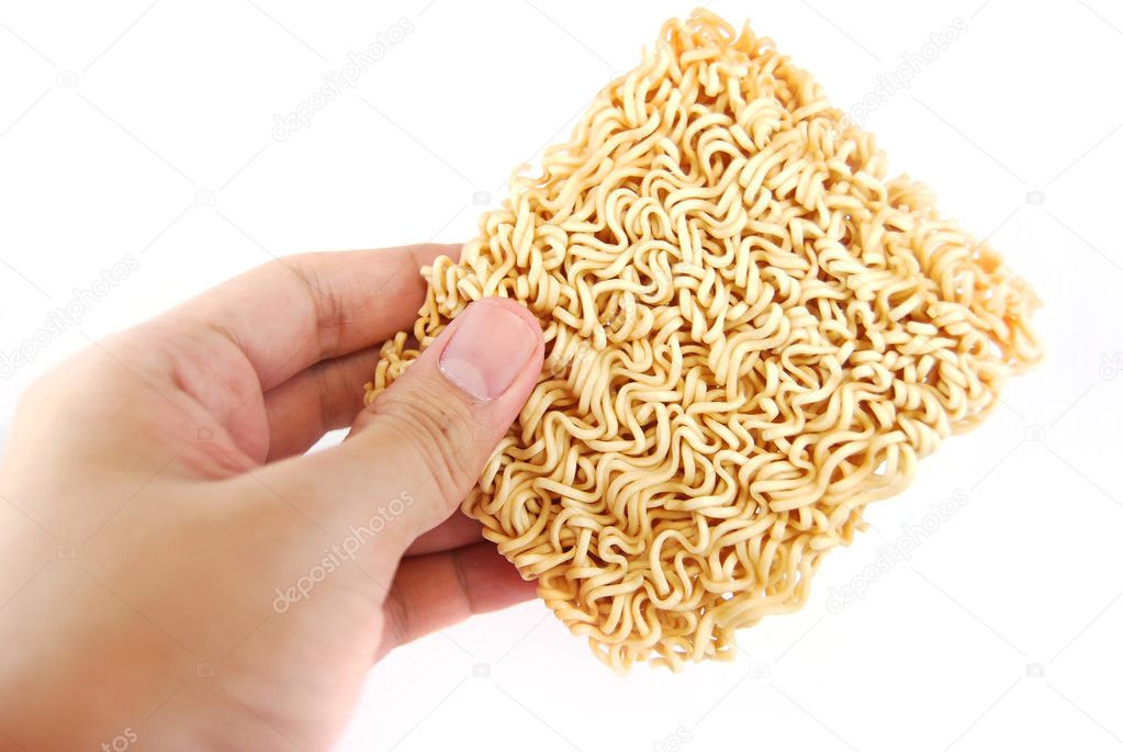 Hand holding a block of Instant noodles isolated on white backgr