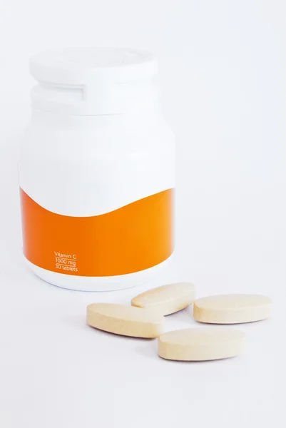 Vitamin c bottle and medicine tablets isolated — Stock Photo, Image