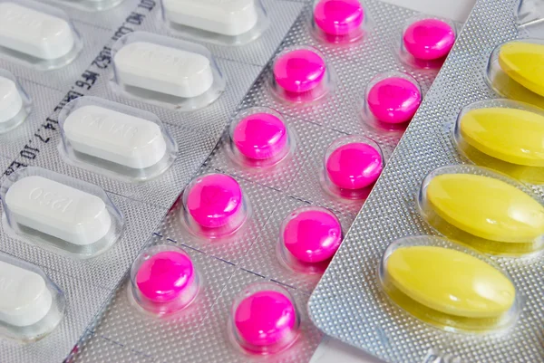 Förpackning med färgglada medicin piller bakgrund — Stockfoto