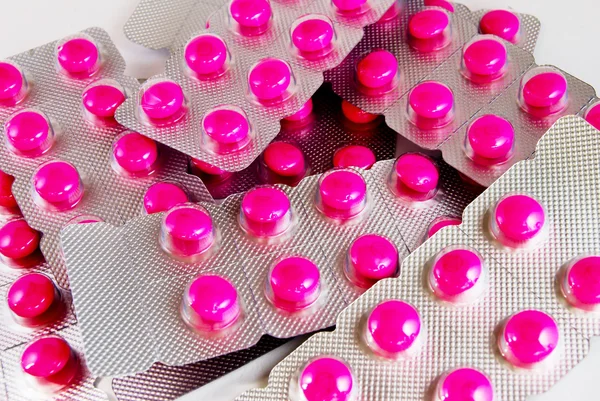 Förpackning med rosa medicin piller bakgrund — Stockfoto