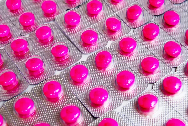 Förpackning med rosa medicin piller bakgrund — Stockfoto