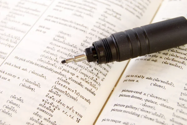 Closeup of old dictionary and pen — Stock Photo, Image