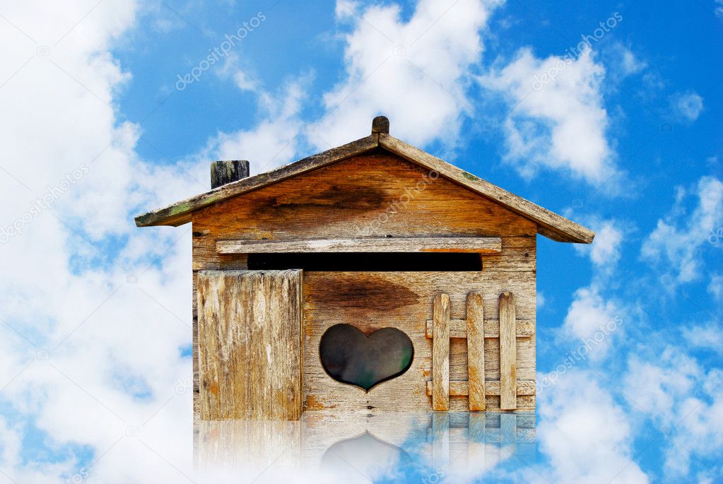 Old wood house postbox on beautiful sky background
