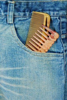 hairdresser jean with two comb in the pocket closeup background clipart