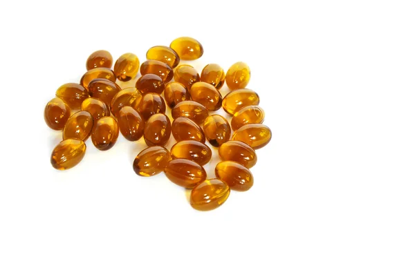 Brown fish oil gel capsule pills closeup — Stock Photo, Image