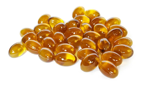 Brown fish oil gel capsule pills closeup — Stock Photo, Image