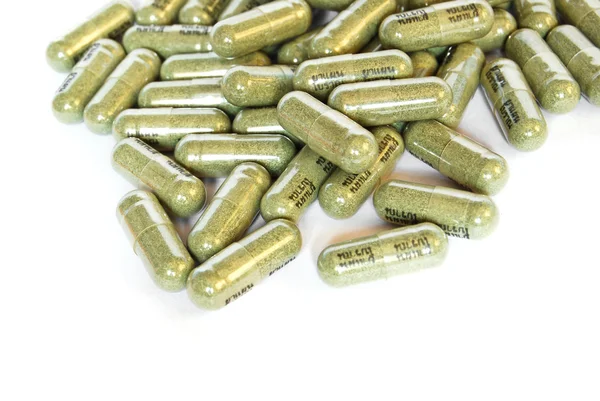 Green herbal medicine capsule — Stock Photo, Image
