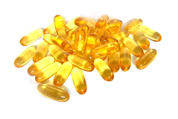 Glänsande gul fisk olja kapsel piller närbild — Stockfoto