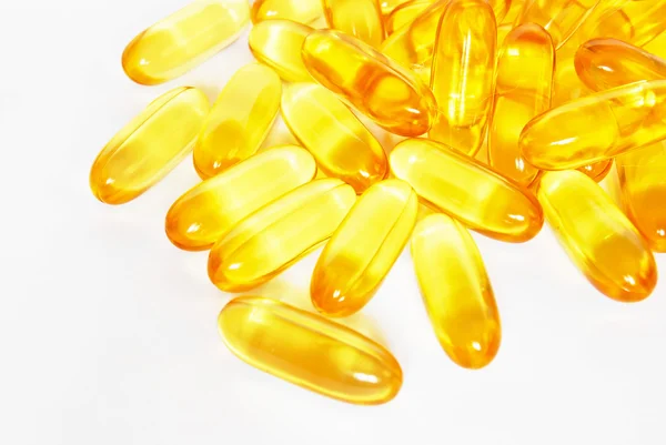 Brillante giallo pillole capsula olio di pesce primo piano — Foto Stock