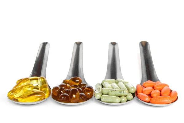 Ложка с цветными витаминными таблетками — стоковое фото