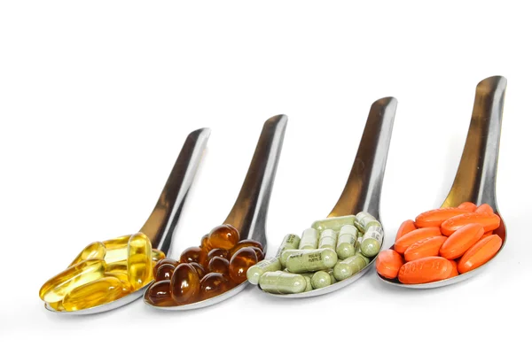 Spoon with colorful vitamin medicine pills — Stock Photo, Image