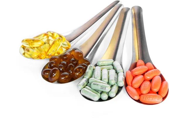 Spoon with colorful vitamin medicine pills — Stock Photo, Image