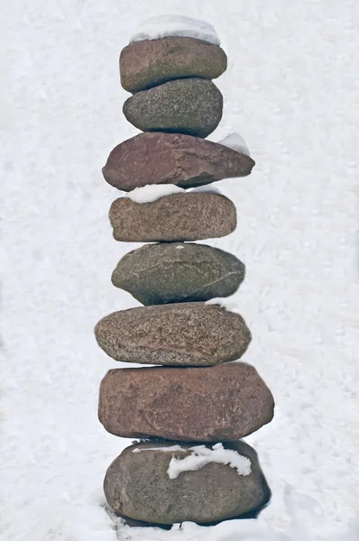Pyramid of stones with snow — Stock Photo, Image