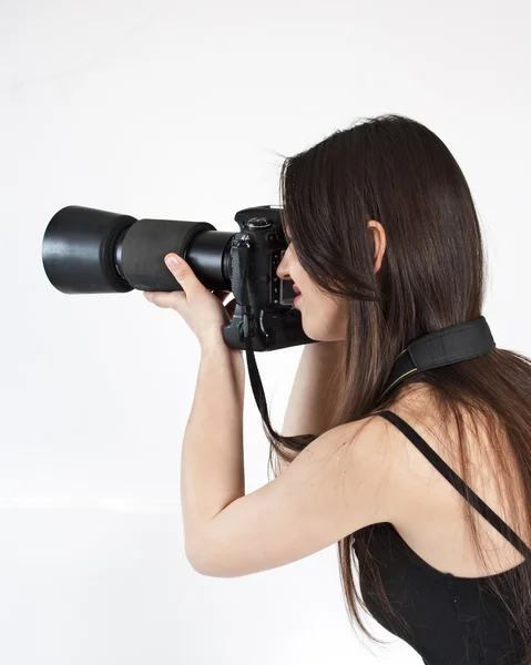 Een jonge vrouwelijke fotograaf met een professionele camera — Stockfoto