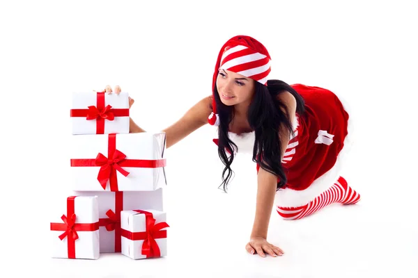 Santa dziewczyna siedzi na jego ręce na kupie prezenty. Święta Bożego Narodzenia — Zdjęcie stockowe