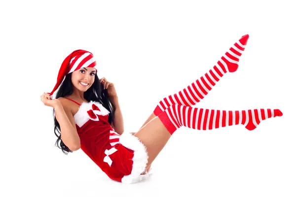 Santa flicka sitter lyfte benen upp. semester jul och nyår. — Stockfoto