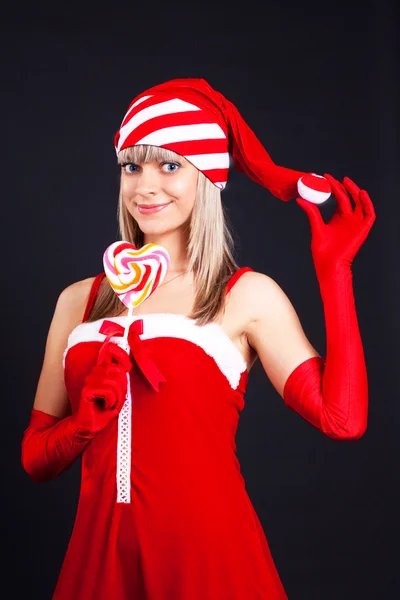 Santa dívka drží lízátko. svátky vánoční a nový rok. — Stock fotografie