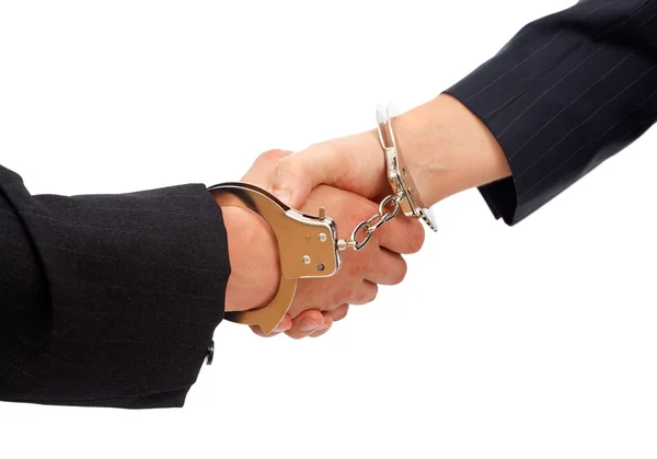 Handshake linked with handcuffs — Stock Photo, Image