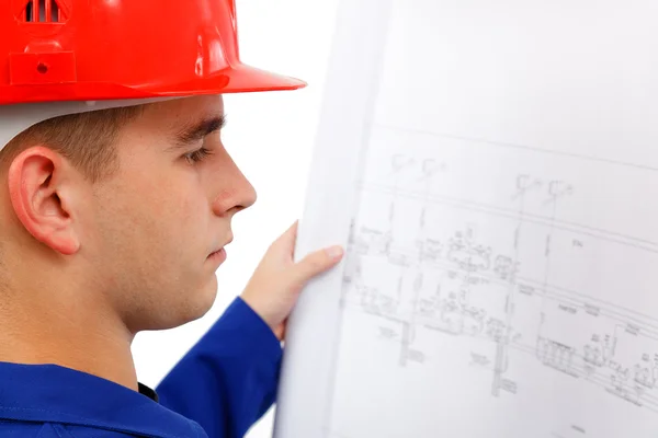 Young construction engineer surveying plans — Stock Photo, Image