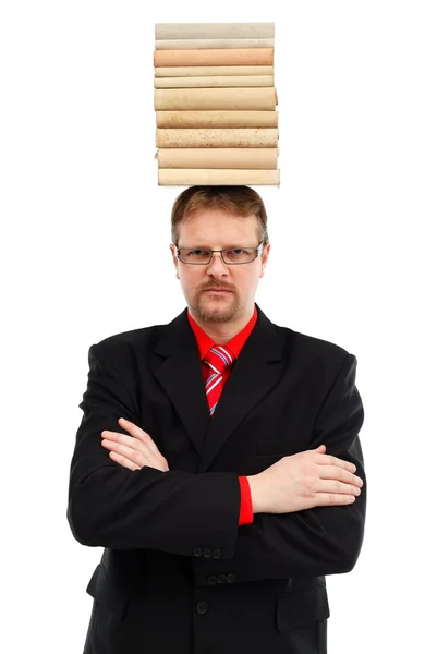 Homem com livros empilhados na cabeça — Fotografia de Stock