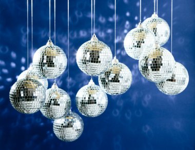 Mirrored disco balls with light spots over background clipart