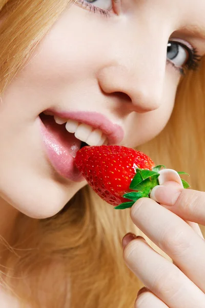 Girl eating strawberry Royalty Free Stock Photos