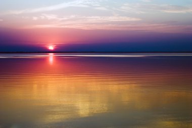 Sunset over water clipart