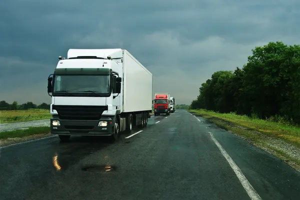 Trucks on wet asphalt — Stock Photo, Image