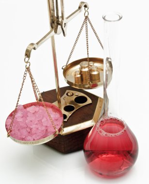 Pharmaceutical scales and red liquid clipart