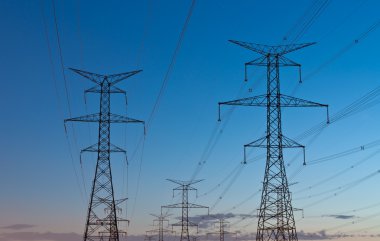 Electrical Transmission Towers (Electricity Pylons) at Dusk clipart