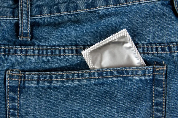 Jeans and condom — Stock Photo, Image