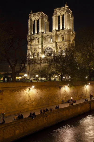 stock image Embankment of Seine River and Notre Dame de Paris at night
