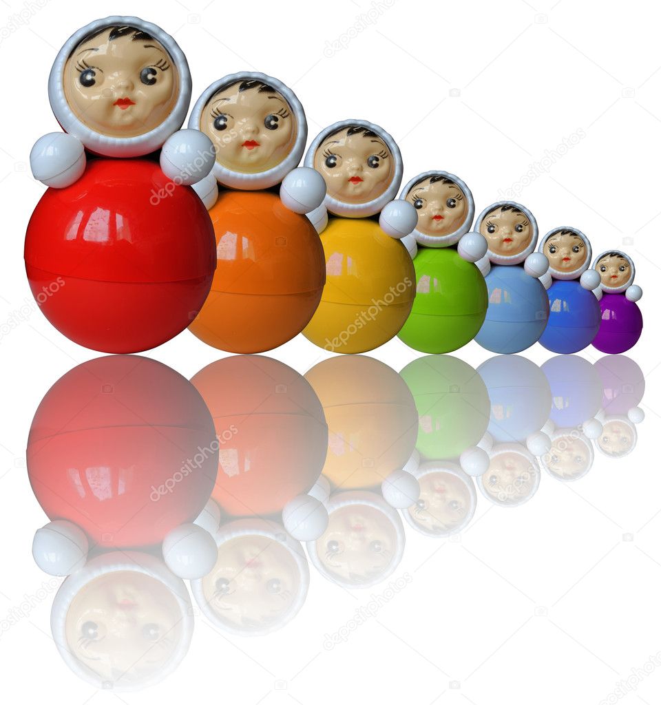 Seven rainbow colored roly-poly toys with reflection (isolated)