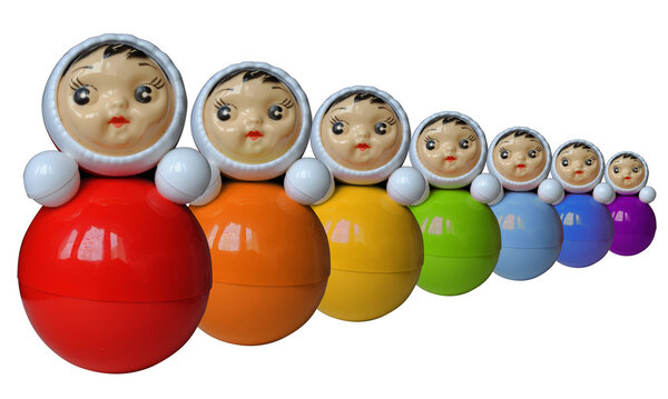 Seven rainbow colored roly-poly toys (isolated)