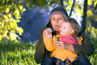 Mother and the daughter on walk in park, a family on the nature clipart