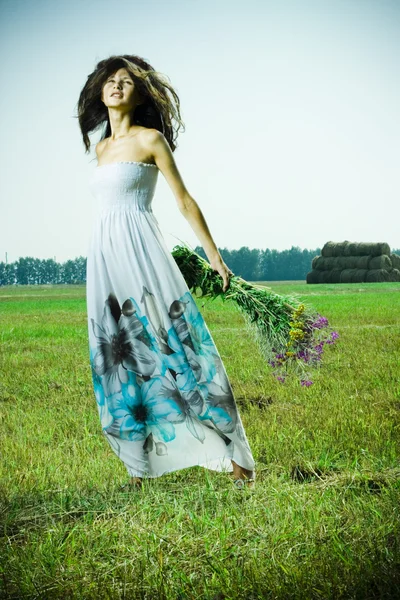 Portrait of beautiful girl in green field — Stock fotografie