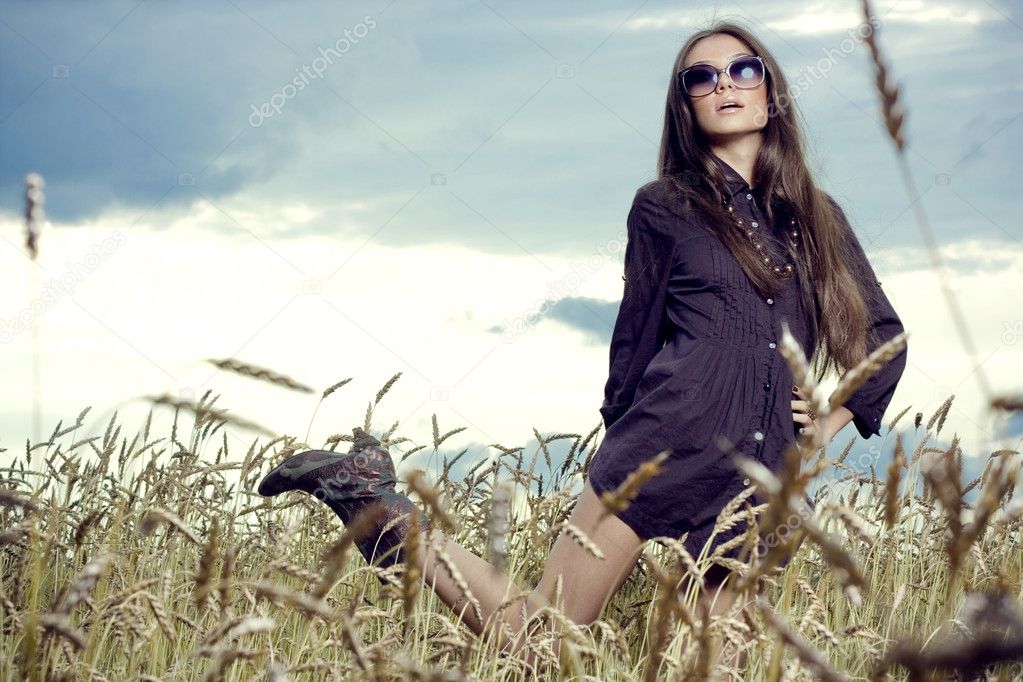 Beautiful brunette girl at the field