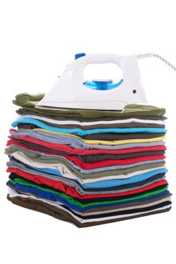 Iron on top of folded shirts in a pile clipart