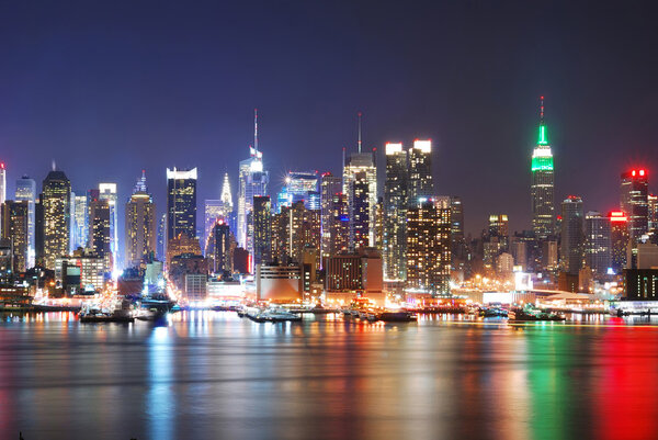 New York City Skyline with Times Square and Empire State Building at night.